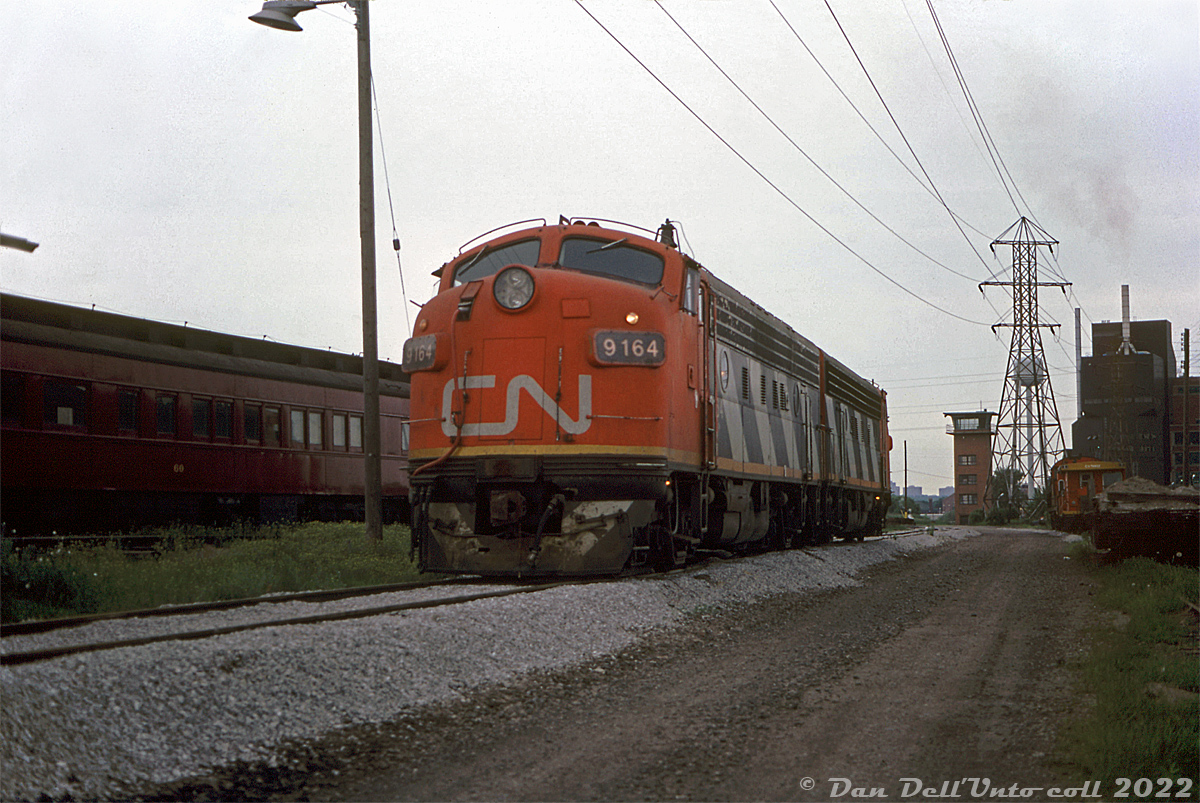 As well as working the Steel Train out of Hamilton, CN's rebuilt F-units also found themselves on local wayfreight and work trains in the 80's. Here, CN F7Au's 9164 and 9169 sit in the TTR's Don Yard south of Cherry Street awaiting their next duties. CP business car 60 sits on an adjacent track.

What appears to be a CN switcher and transfer caboose sit on another track near the old Don Yard yard tower (single-level at the top, like the ones at Mimico and Canpa, but unlike the one at Bathurst Street). Also in the background is the Lever Brothers soap factory (opened in the early 1950's, closed in the late 2000's) at the foot of the Don River. Today the F's and yard tower are gone, but Don Yard still sees use as a layover facility for GO Transit.

Original photographer unknown, Dan Dell'Unto collection.