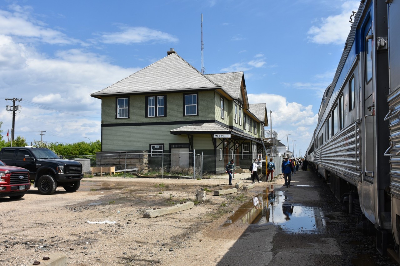 The ever ongoing exterior restoration of the CN Melville, SK station is evident in this June 8, 2022 photo, as it was during two previous trips on The Canadian in March of 2020, and December 2021. Scaffolding and leaning ladders still adorn the outside of the building behind a Frost security fence as passengers from VIA #2 mill about the puddled platform enjoying some fresh air and leg stretching. Meanwhile, a crew change is taking place up ahead at the lead locomotive. Of note, at the upper right corner of this photo is the original coal oil marker lamp hanger bracket still attached to the end of the Skyline car. I noticed a number of these brackets still adorning a variety of these old stainless steel cars on The Canadian equipment, and cars assigned to the Churchill trains as well. On many cars, these marker lamp fixtures had been removed and patched over with a stainless steel plate.