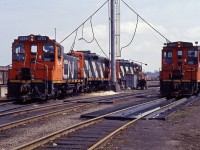 Back in 1990, Hamilton Yard was still a "going concern" operating 13 yard assignments on weekdays, while originating 5 wayfreights (555 to the Halton sub, 556, 557, and 558  to the Oakville sub, and 562 to the Grimsby sub), as well as Mac Yard turn 444 and 725 to Nanticoke. Power for some yard assignments--normally SW1200RS units by this time--was kept in the North Yard (or Parkdale for assignments starting there) while other yard and wayfreight engines (GP9s or GP9RMs) were kept at the Diesel Shop. Train 419 handled Sarnia traffic, train 333 took Black Rock (Buffalo) cars while 332 brought cars from the U.S., with trains 448 and 449 taking traffic between Niagara Falls and MacMillan Yard. With that for context, we see SW1200RSs 1254, 1289, and another "pup" as well as GP9 4371 (built as the 4112) and 4105 (rebuilt from the 4126) awaiting their next assignments at the Hamilton Yard diesel shop in the spring of 1990. [Train information from a January 1990 CN assignments document.)