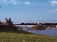 CN train 535 ("the South" roadswitcher) crosses the Grand River in Caledonia behind a pair of SW1200Rs units, the usual power in the 1970s. This train would travel up Hamilton's Ferguson Avenue twice per day until the 1980s when service was re-routed through Brantford.