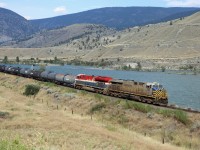 This westbound certainly generated a frantic stop. We were driving east from Spences Bridge towards "the fruit stand" when this westbound came around the bend with CN 3913 (a former CREX unit) and BC Rail heritage unit 3115! All's well that ends well--we got set up in time with this result.