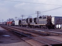 There's only a little snow on the ground here in Burlington in early 1966 as an eastbound freight starts up the Halton sub behind CN GP9 4491 and RS18 3659. While these units haven't been repainted, the new image is now starting to show up on some cars in the consist and many locomotives.