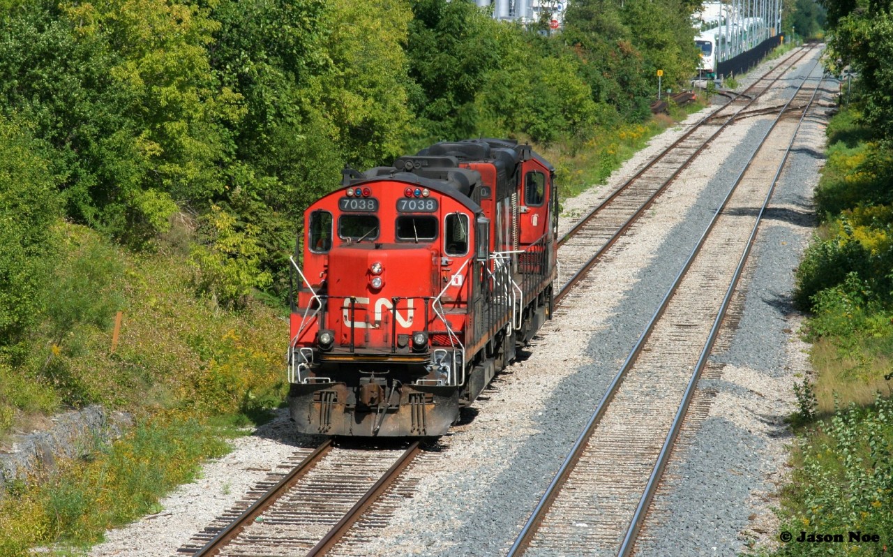 CN X540 with 4130 and 7038 are backing down the siding in Kitchener to the yard where they will build their train for Guelph before departing. September 6, 2021.
