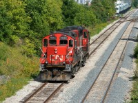 CN X540 with 4130 and 7038 are backing down the siding in Kitchener to the yard where they will build their train for Guelph before departing. September 6, 2021.