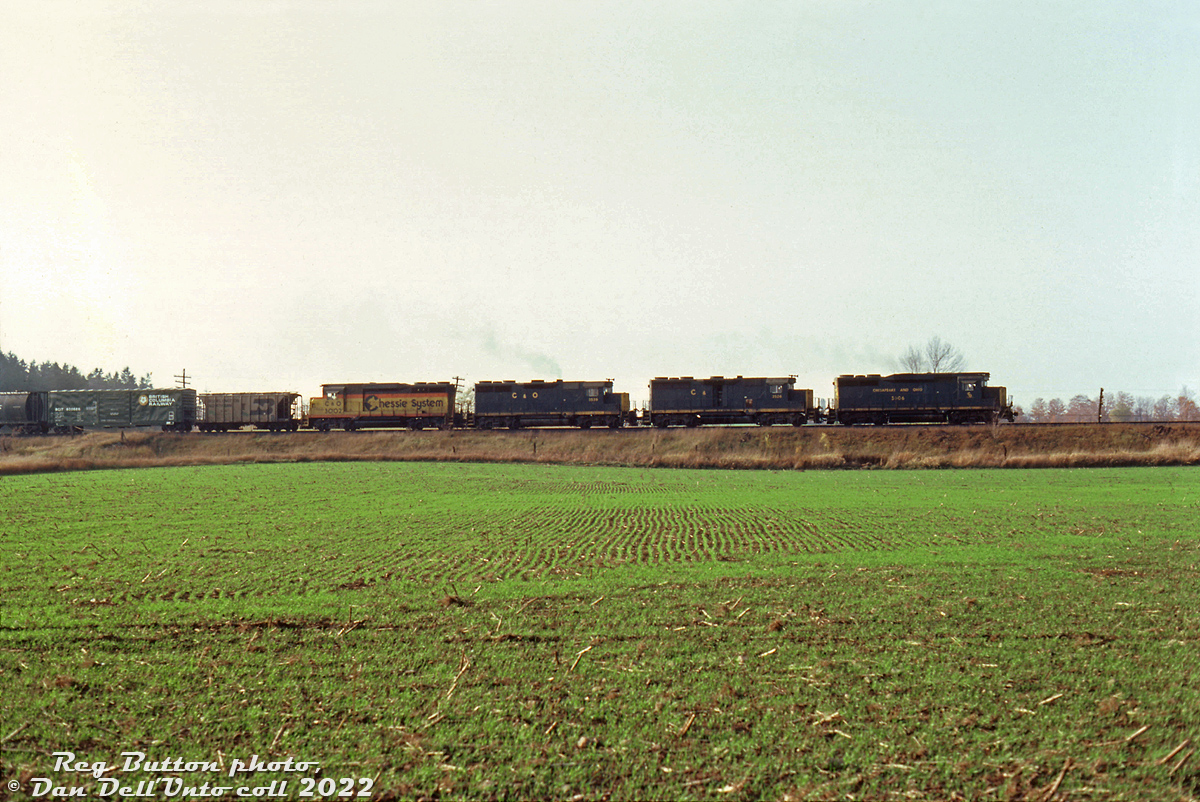 Borrowed Chessie power was common on CP around this time, and four such units are shown loaning their horsepower here: Chesapeake & Ohio GP30 units 3006 & 3002 (the latter in the newer Chessie System colours) sandwich GP35's 3526 & 3539 on CP freight #52, rolling past the fields at Puslinch on CP's Galt Subdivision. C&O purchased a sizable quantity of GP30 units, EMD's stylish 2250hp turbocharged second generation 4-axle model of the early 60's, and followed up with more of the upgraded GP35 model (that boosed the 567D to 2500hp, but did away with the extra styling). They were both commom mainline power on C&O's own lines in southern Ontario too.