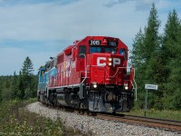 Just moments after the last shot CP G22 passes by the Station Name Sign Spruce as it heads past the forests on the Sherbrooke sub