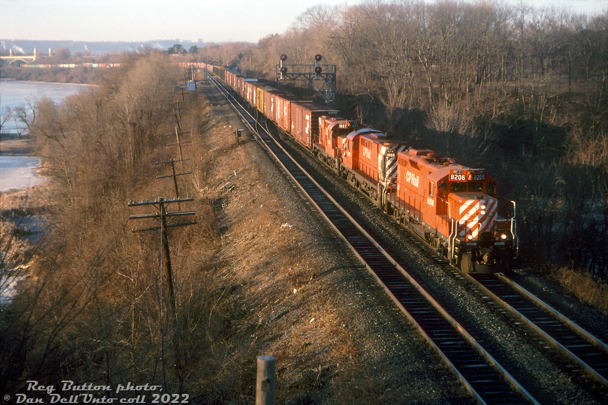 Early bird gets the BUCP: Reg was at the Bayview Junction footbridge one morning to catch CP's BUCP freight (CR Buffalo to CP Toronto Yard) rolling through Bayview Junction, using trackage rights over CN's Oakville Sub to Canpa. CP rebuilt GP9u 8206 leads RS18u units 1805 & 1807, with a lengthy train stretched out under the York Blvd. bridge coming off CP at Hamilton Junction.