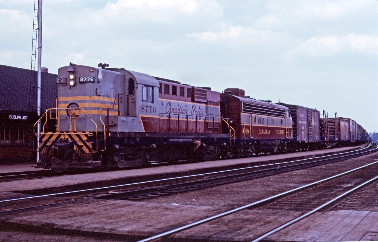 Running extra, CP RS18 8776 and FP7 4068 crest the hill at Guelph Jct with a westbound in the spring of 1966.