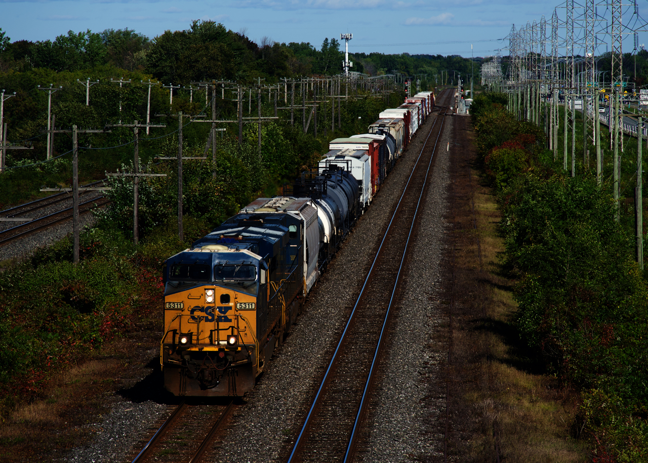 CN 327 has a pair of ES40DCs (CSXT 5311 & CSXT 5491) and 58 cars as it passes the plant at Caron.