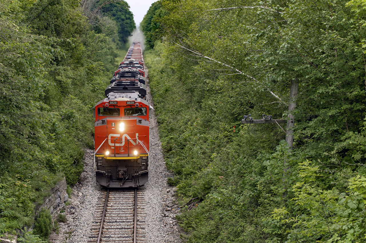 Making a daylight appearance after being scheduled to run the previous night, CN W933 slowly climbs the grade at Limehouse while dumping ballast from Silver to Guelph.