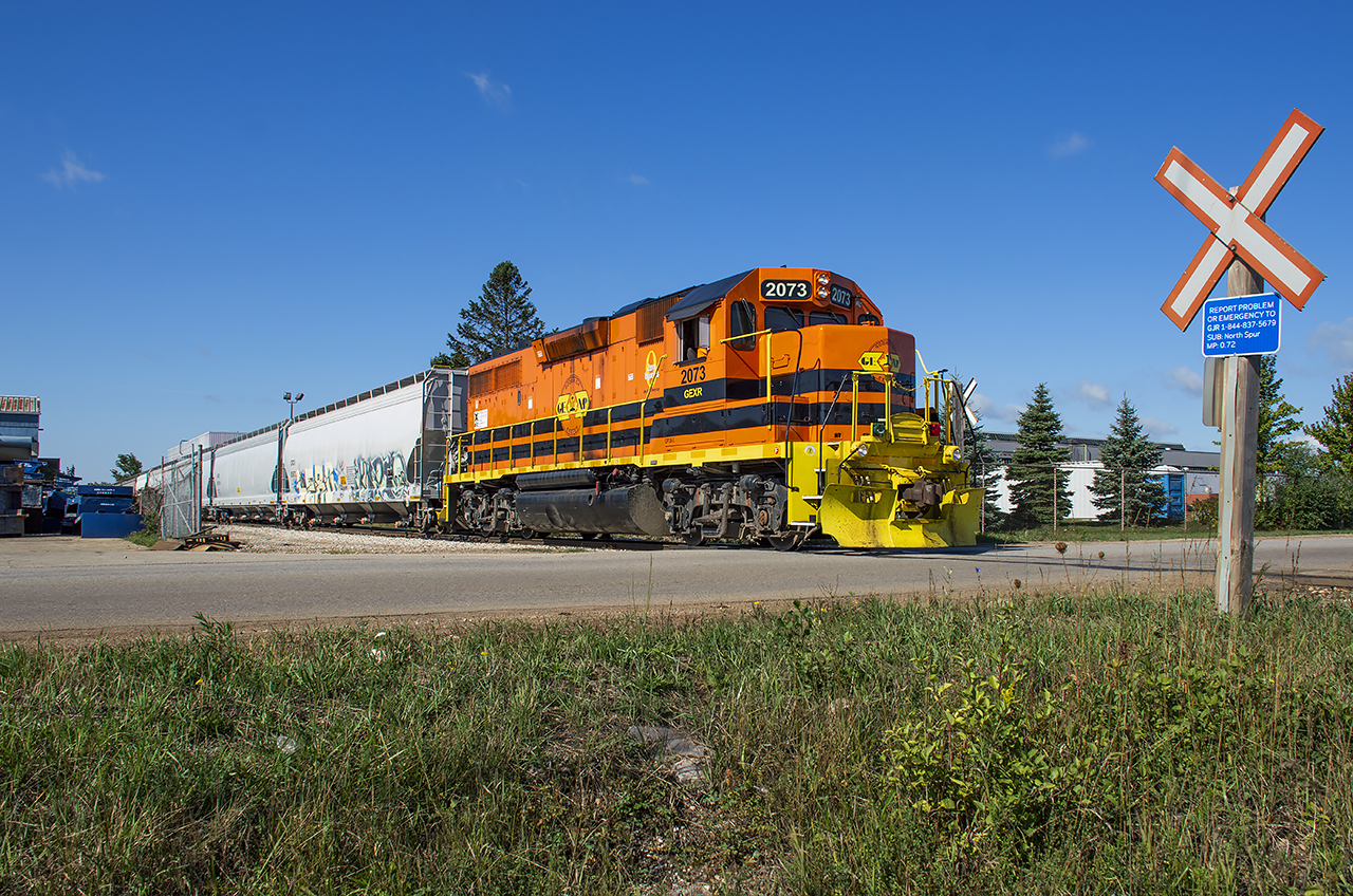 The Guelph Junction Railway's north industrial area is a busy operation shared both by GEXR and CN, with customers receiving service from either or both railways.  With their drop at the interchange complete, GEXR 582 pulls ahead to clear the wye on the North Industrial Lead, giving CN L542 a chance to pull clear of the South Industrial, and back around the wye.  582 will head for the South Industrial while L542 will lift its interchange traffic and return to home rails.
