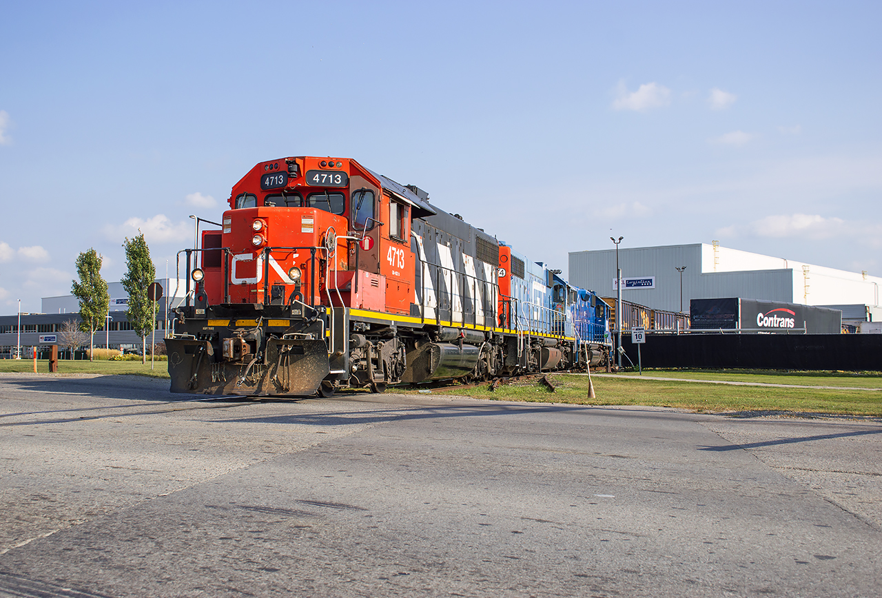 CN L568 lifts traffic out of HCL Logistics on the Oxford Spur.  Having worked Stratford Yard and Agromart on their westward trip, they will have a straight shot home to Kitchener after spotting inbound cars.