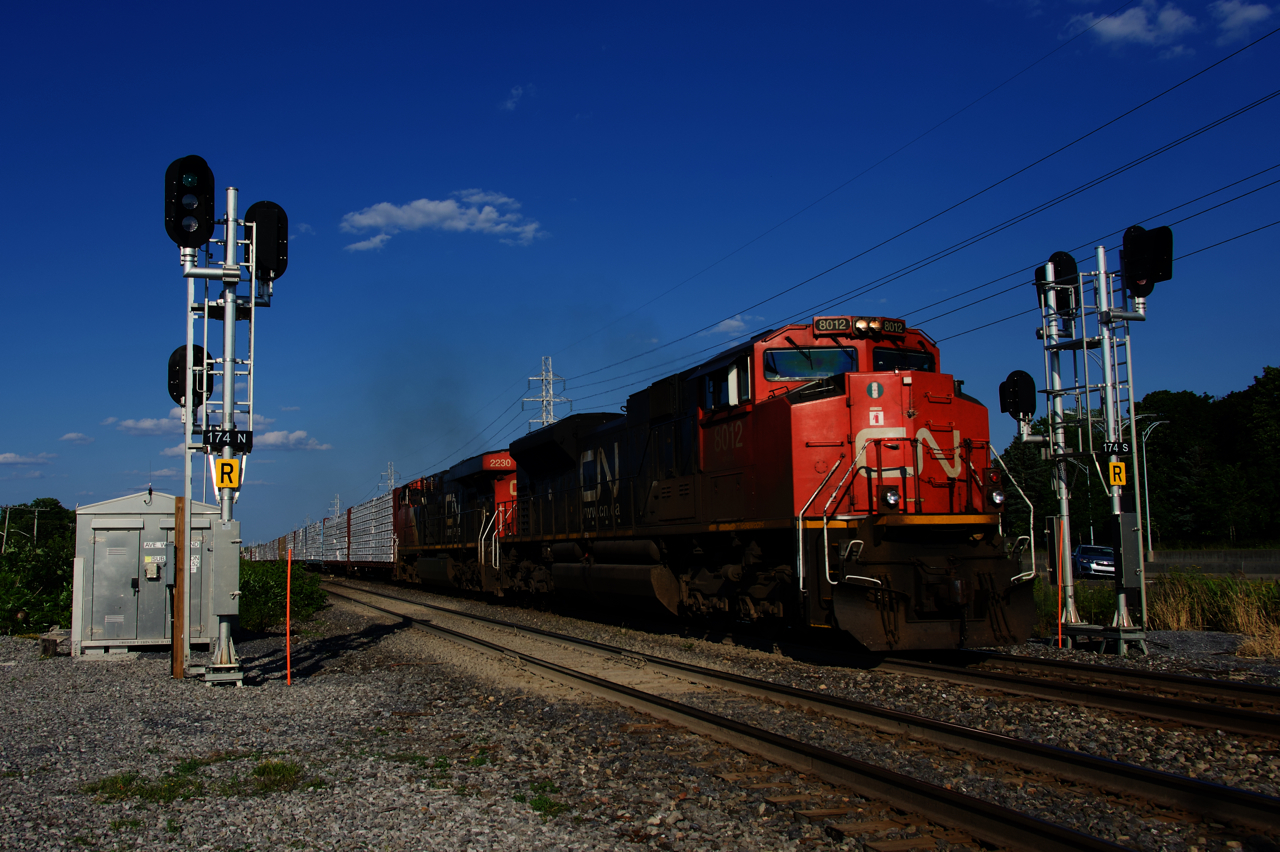 CN X377 is splitting a fairly new set of signals at MP 17.4 of CN's Kingston Sub. At left CN 122 is lined on the South Track.