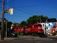 CP H41 is about to cross the intersection of Gage Avenue and Main Street as it heads to the Beach Branch to serve a couple of customers.