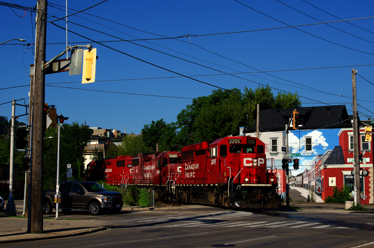 CP H41 is about to cross the intersection of Gage Avenue and Main Street as it heads to the Beach Branch to serve a couple of customers.