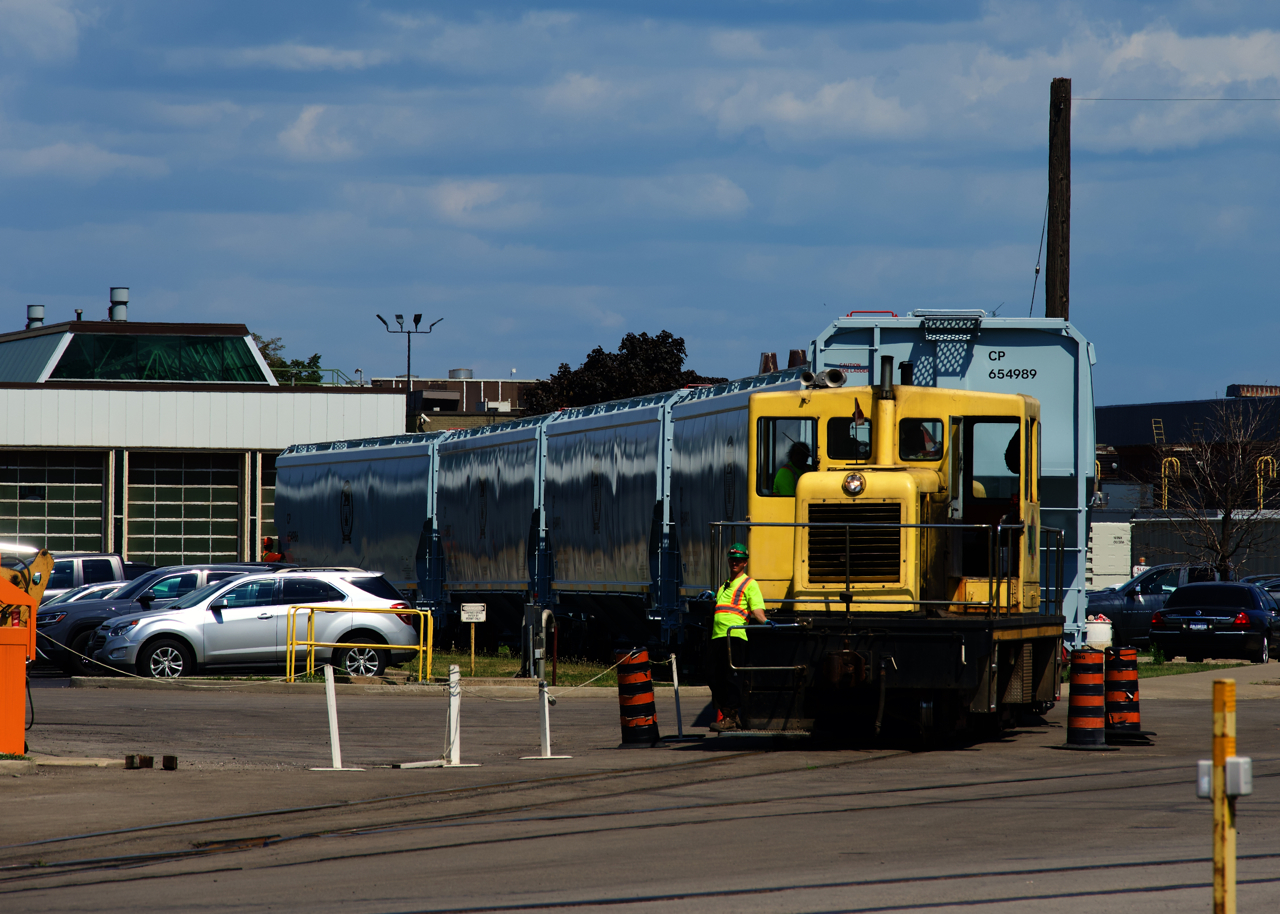 One of National Steel Car's two 50-tonners is pulling six new CP grain cars out of a building as they get ready to back the cars into another section of the plant. This unit was built in 1954 and has spent its entire career here.