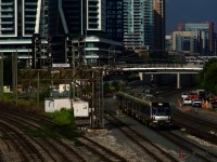 A Union Pearson Express train is passing a trio of searchlight signals, the middle one displaying a clear signal for a westbound.