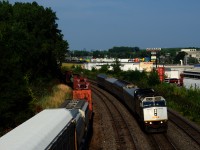 VIA 37 has a peculiar consist, with two LRC cars split by two HEP cars. VIA 6436 leads the train towards its next stop at Dorval.