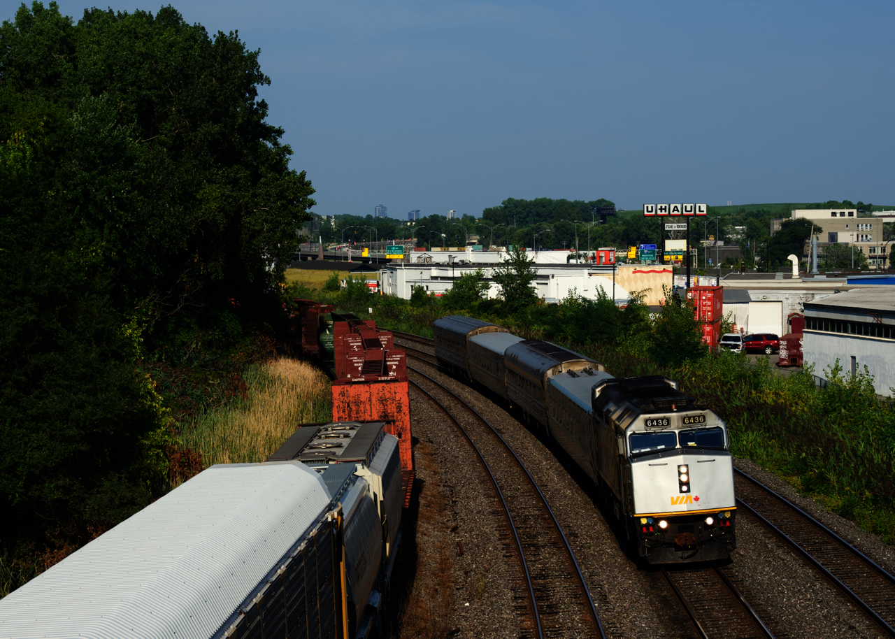 VIA 37 has a peculiar consist, with two LRC cars split by two HEP cars. VIA 6436 leads the train towards its next stop at Dorval.