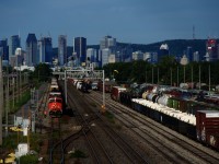 The conductor has gotten off CN 310s leader as the train arrives at Southwark Yard. He will throw a switch in a bit so that the train can be yarded into the tracks at left.
