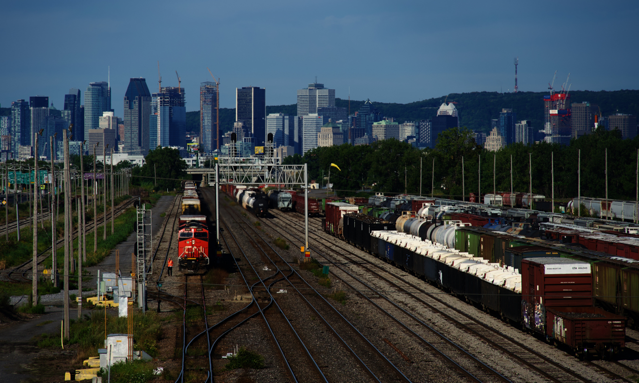 The conductor has gotten off CN 310s leader as the train arrives at Southwark Yard. He will throw a switch in a bit so that the train can be yarded into the tracks at left.