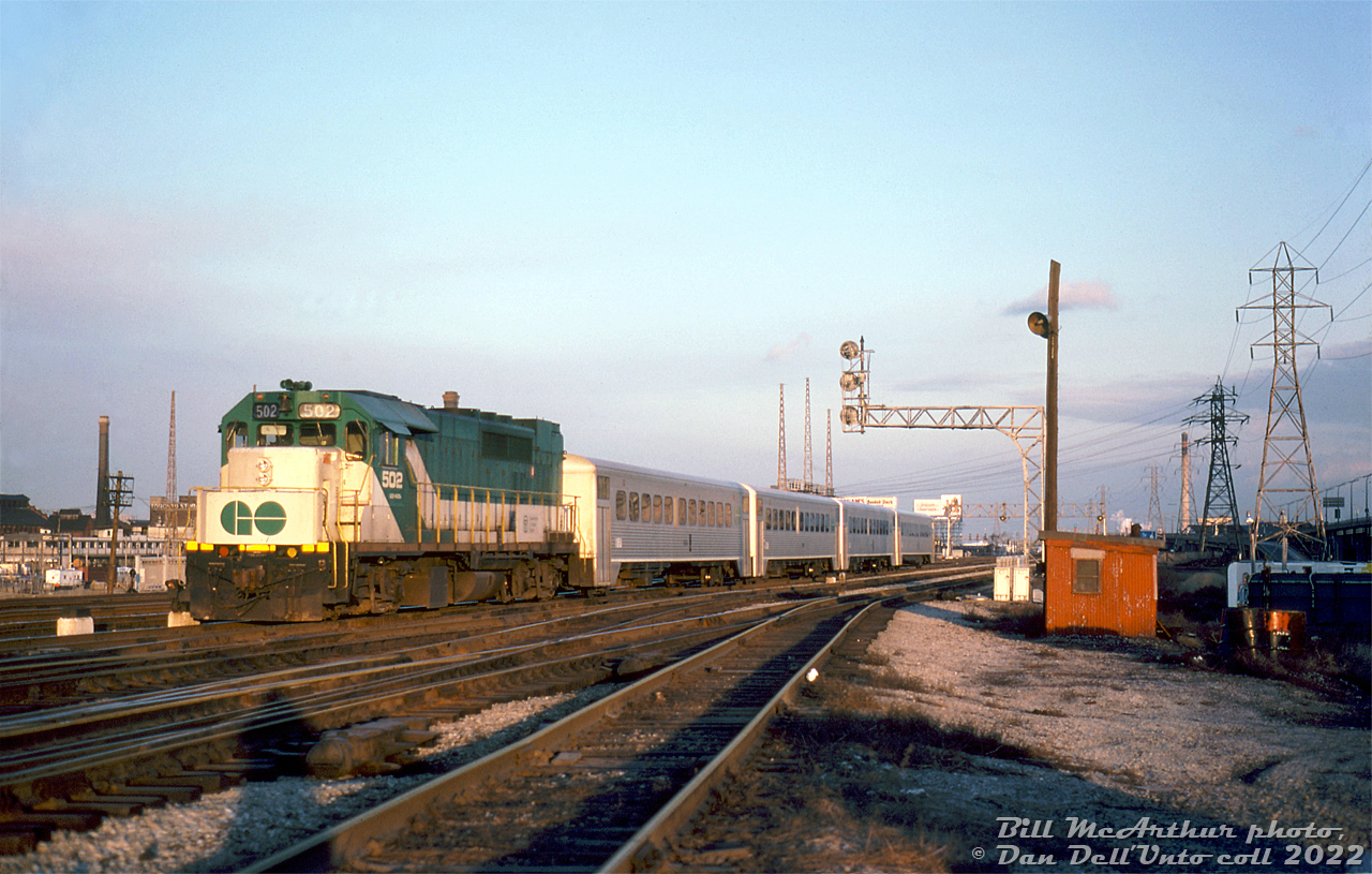 Trailing a short 4-car train of Hawker Siddeley single level commuter cars, GO Transit GP40TC 502 pushes eastward out of Union Station past the east switches of the "High Line" near the TTR Scott Street interlocking tower. One can see some of the industrial lands at the left that once populated the "West Donlands" area east of Yonge Street.

Bill McArthur photo, Dan Dell'Unto collection slide.