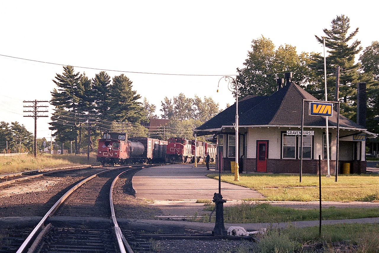 I was worried that the sun was going to set before CN trains #450 and 451 showed at Gravenhurst, as the day comes to a close early in September. And too bad the "meet" was a bit down the line, but better than no meet at all.
I missed #450 as I heard it from the other side of town, but fortunately #451 northbound showed up.  CN 9426, 9619, 9694, 9447, 9603 and 4521 made my run over to the station worthwhile. Beautiful evening to be shooting the breeze on the back of the caboose heading south. Such a shame trains are now cabooseless.
CN 451 and 450 ran between Toronto and North Bay (ONR) and I understand they still do, although no longer daily.