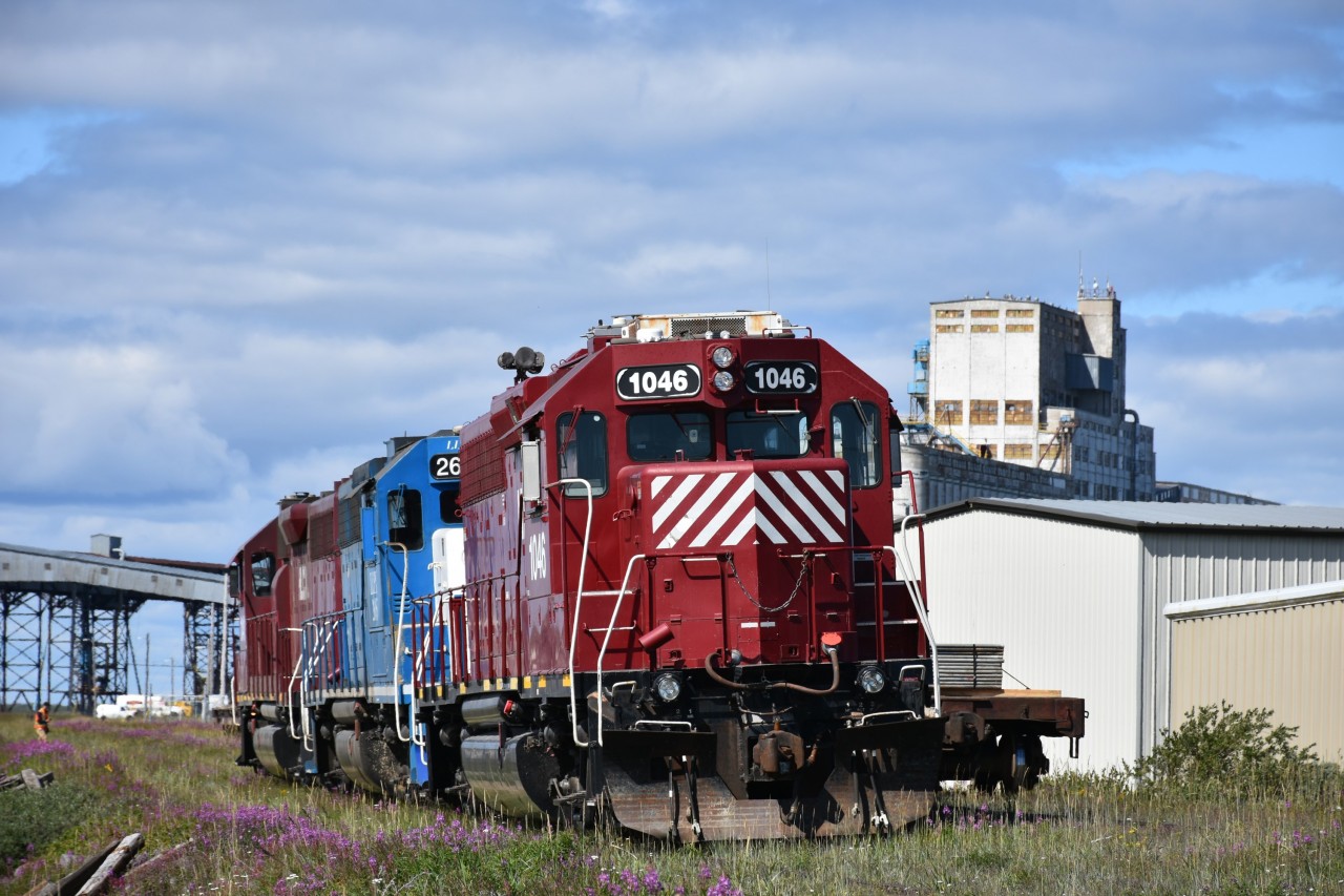 HLCX 1046 trails lead unit HLCX 1041 and sandwiched LLPX 2605 on ZC Zone track 50 as they run around a cut of cars on the grain elevator lead north of the station and end of subdivision point in Churchill. MB. This trio of units has been marshalling cars into order for placement in the yard and at various unloading locations.
