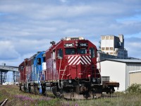 HLCX 1046 trails lead unit HLCX 1041 and sandwiched LLPX 2605 on ZC Zone track 50 as they run around a cut of cars on the grain elevator lead north of the station and end of subdivision point in Churchill. MB. This trio of units has been marshalling cars into order for placement in the yard and at various unloading locations.