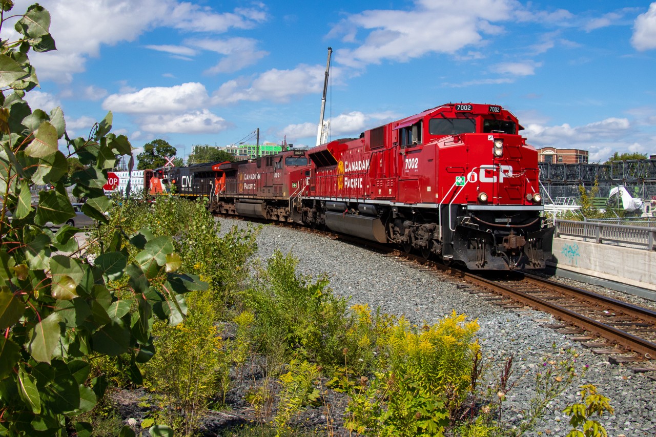 CP 9-420 winds around the west leg of the West Toronto wye with a bright & shiny CP 7002 leading CP 8031 and CN 3143. This train was delayed for hours as it traversed the Mactier sub and by the time it got to West Toronto, CP's West Tower asked them to dump the train in Lambton instead of going east to Agincourt. The result is this, the rare use of the West wye leg in daylight. To top it off, a recent return from AMP meant CP 7002 looked brand new, sparkling in the midday sun.