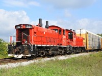 The Woodstock Job with OSR 1244 and 1210 slows to allow a ballast regulator to move west so they could clear the west wye switch at Cami to then reverse their train of auto racks into the yard.  They sure sounded good shoving up the hill to Cami.