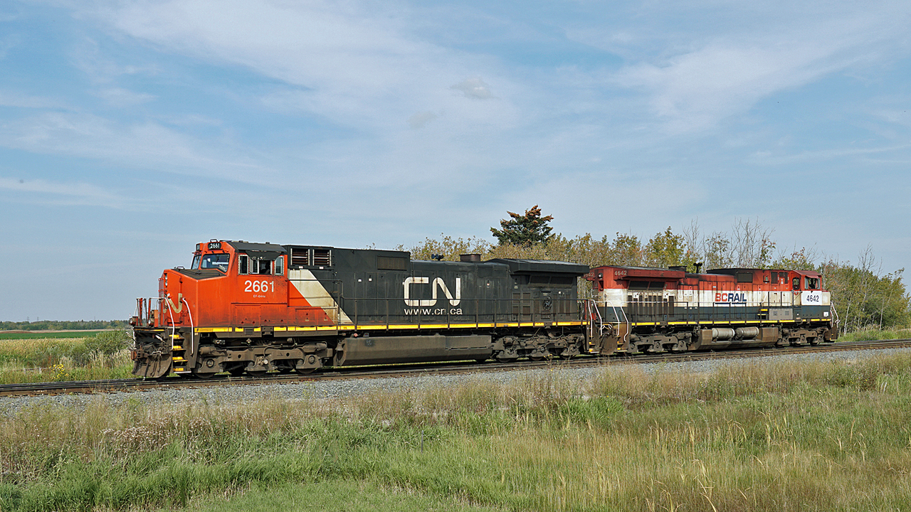 CN 2661 and BCOL 4642 make a light engine move into Scotford Yard.  They have been working at the Heartland Sulphur Terminal a couple of miles to the east and are returning to the yard shop tracks for a break.  Nice to see the old BC paint scheme, getting pretty rare these days.