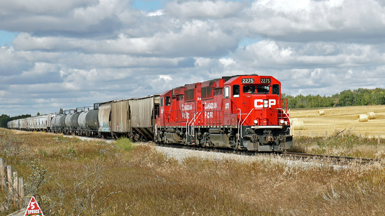 A pair of GP20C-ECO, CP 2275 and 2233 travel east on the Lacombe Sub with the Red Deer to Stettler local.  Seen here about to cross Hyw 11.