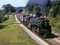 Following up on <a href=http://www.railpictures.ca/?attachment_id=50030>Steve's recent time machine</a> shot of <a href=http://www.railpictures.ca/?attachment_id=7028>Arnold's 1980 image,</a> we look back another few decades to the last decade of steam.  CNR U-2-a, 4-8-4 6115 (CLC, 1927) heads eastbound at John Avenue in Paris.  Note at upper left the <a href=http://www.railpictures.ca/?attachment_id=14612>Medusa White Cement</a> company building in the distance at Paris Junction.<br><br><i>Original Photographer Unknown, Jacob Patterson Collection Slide.</i>