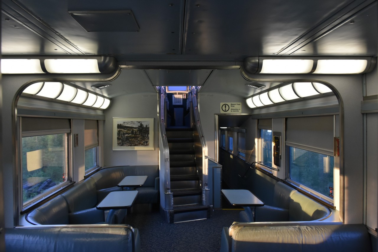 It's not the Stairway to Heaven but it sure was an enjoyable climb every time I went up into the dome level of VIA 8515 Skyline on VIA #693. It's 05:38 and the train is 3 hours & 20 minutes (67 miles) south of Churchill, MB. There's no one else in the Skyline car but me and a VIA on-board attendant who was making a fresh carafe of coffee. A fresh cooked breakfast is still an hour and a half away. There's not much to look at outside as we rumble north, but it's amazing how interesting every mile of barren, tree pegged tundra and mirror like lakes can be from this elevated vantage point.