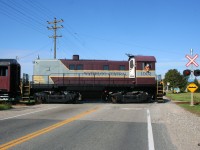 Following an extended hiatus due to the global pandemic, the first revenue Waterloo-Central Railway train to operate in over two years is viewed crossing King Street north of Waterloo, Ontario with S13 1002 leading towards St. Jacobs and Elmira. 
