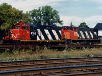 A RaiLink Southern Ontario Railway (RLK) power set is seen laying over in Paris, Ontario with CN 4109 and RLK 3508 with the CN Dundas Subdivision in the foreground.
<br>
CN GP9RM 4109 was likely leased at the time. The track the units are sitting on is the CN Dumfries Spur, which went to the Wabco Plant that had closed during the 1970’s. This track at one time crossed Market Street. CN 4109 was eventually retired and is now CBFX 900, while RLK 3508 was sold to the Hudson Bay Railroad and ultimately scrapped. 
