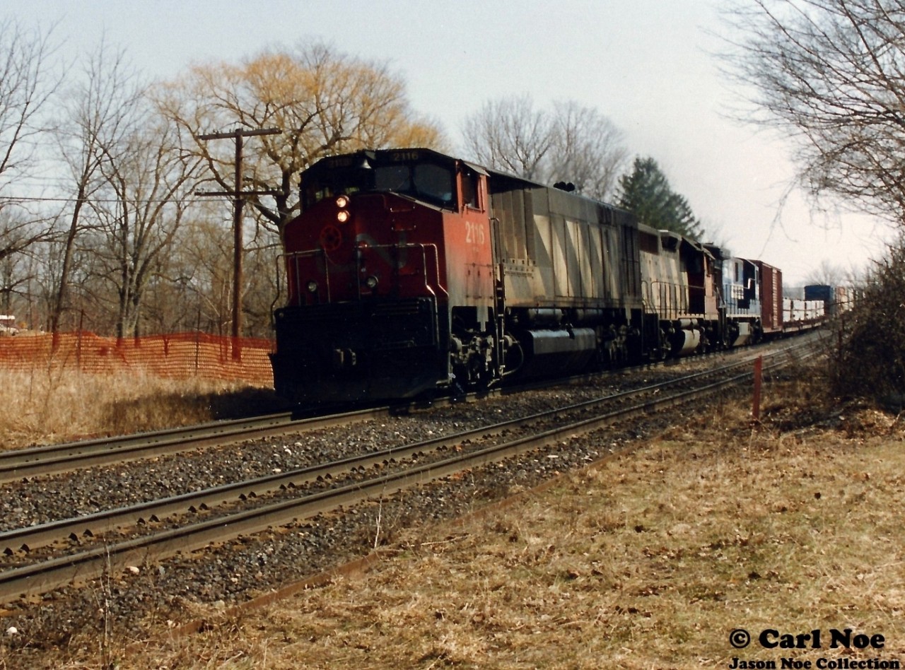 CN 2116, 9313 and Conrail 6580 lead a morning westbound across the large Grand River trestle in Paris, Ontario on CN’s Dundas Subdivision about to pass the site of the former Paris train station.