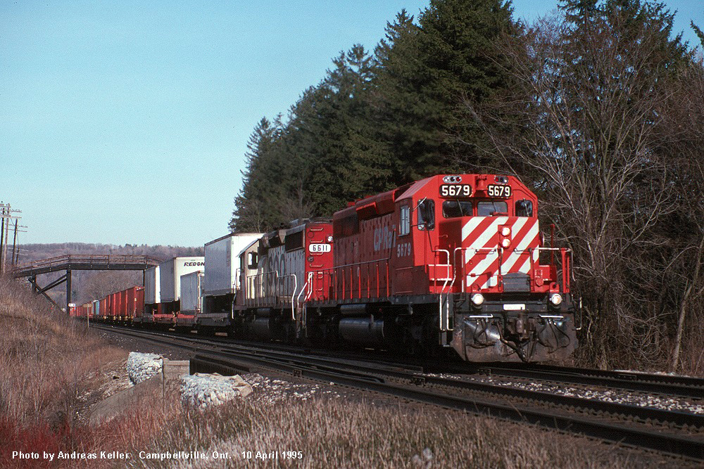 Canadian Pacific SD40-2 5679 and SOO Line SD40-2 6611 leading a westbound TOFC train approaching Canyon Road on April 10th, 1995