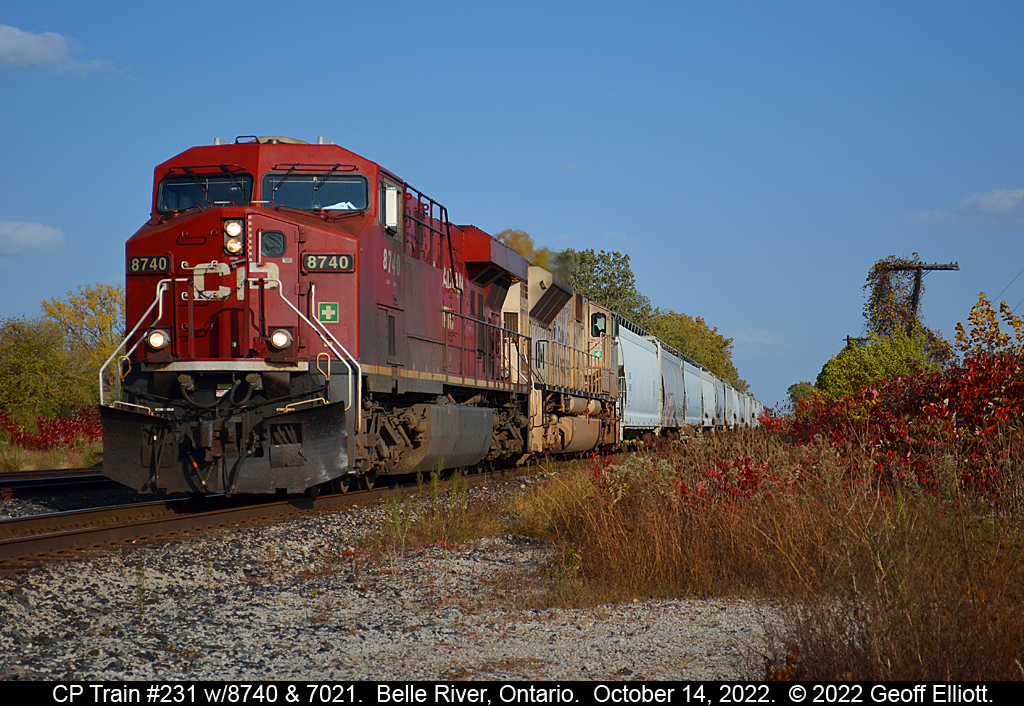 CP train #231 rolls through Belle River, Ontario on October 14, 2022 with CP GE #8740 and CP SD70ACu #7021.  The crossing signals activated as I crossed the tracks so this was a 'bail and shoot' situation that turned out reasonably well.