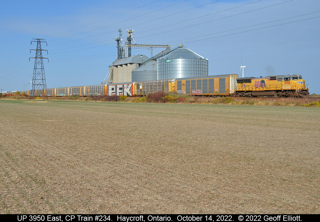 With winter wheat coming up, CP train #234 rolls by the huge AGRIS Co-op in Haycroft, Ontario with Union Pacific SD75M #3950 leading the way on October 14, 2022.