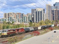 CP 236 with a clean “heritage unit” up front makes its way through the urban sprawl at Obico as a subway passes behind 