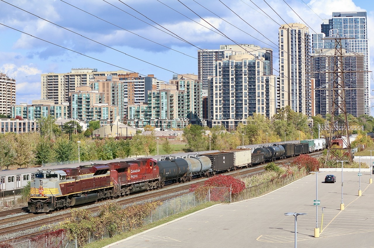 CP 236 with a clean “heritage unit” up front makes its way through the urban sprawl at Obico as a subway passes behind