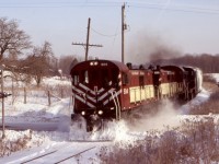 While I have never been a big end cab switcher person, I gained an appreciation for the former CP RS23’s after many years of Railfaning the OSR. While the MLW S13 was built mainly for yard work, the almost identical RS23 rides in road switcher trucks allowing it to be just as useful on branchlines and mainlines as in the yard. Nicknamed “rockets” OSR’s handful of RS23’s were kept busy on the Guelph junction railway over the years and often operated not just in pairs but often as a trio. “Danger crossing “ was a favourite spot of mine on the line, this day a road plow recently passed making the scene a bit more dramatic as the trio heads north to Guelph. 