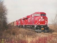 In their very first week of service, new GEs CP 8809, 8813 and 8812 hustle eastward on a clearance from Kinnear to Welland. This image was shot just before the train crossed Mud St in Grassie on a humid, hazy fall day which left the skies looking as clear as...well, mud.