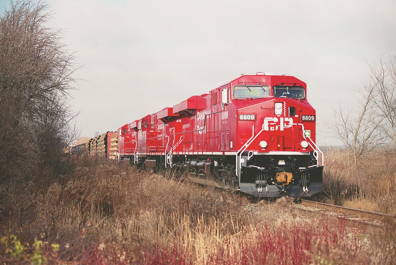 In their very first week of service, new GEs CP 8809, 8813 and 8812 hustle eastward on a clearance from Kinnear to Welland. This image was shot just before the train crossed Mud St in Grassie on a humid, hazy fall day which left the skies looking as clear as...well, mud.