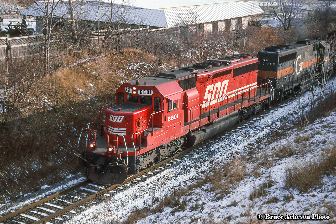 A northbound climbs the grade out of Hamilton on approach to Waterdown ducking beneath Old York Road.  Trailing the 6601 is one of CP's mid 90's rent-a-wrecks in the form of HATX GP40-2 500, now working on Omnitrax' Georgia & Florida Railway.