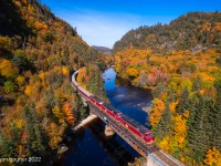 Emerging from the Canyon under spectacular autumn skies, a trio of EMD F40PHR locomotives hustle Watco's sold-out Agawa Canyon Tour Train over the Mile 112 trestle on the "new ACR". In February 2022, Watco purchased the old Algoma Central line from Canadian National, tastefully naming it the Agawa Canyon Railroad and resuming tour train operations for the world to enjoy. On this day, 846 passengers from around the globe were able to take in the autumnal splendour of Agawa Canyon; the crown jewel of Algoma Country.