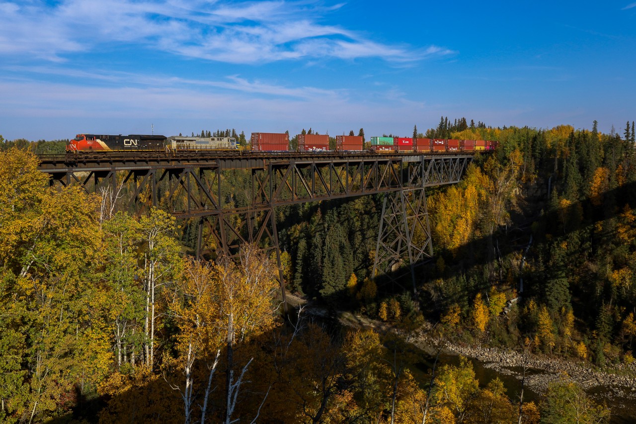 While we may not get the vibrant fall colours that Ontario enjoys, the Pembina River Valley always provides a nice backdrop in the fall.  Calgary to Vancouver train Q 14751 28 highballs through Entistle, as seen from the Yellowhead Highway
