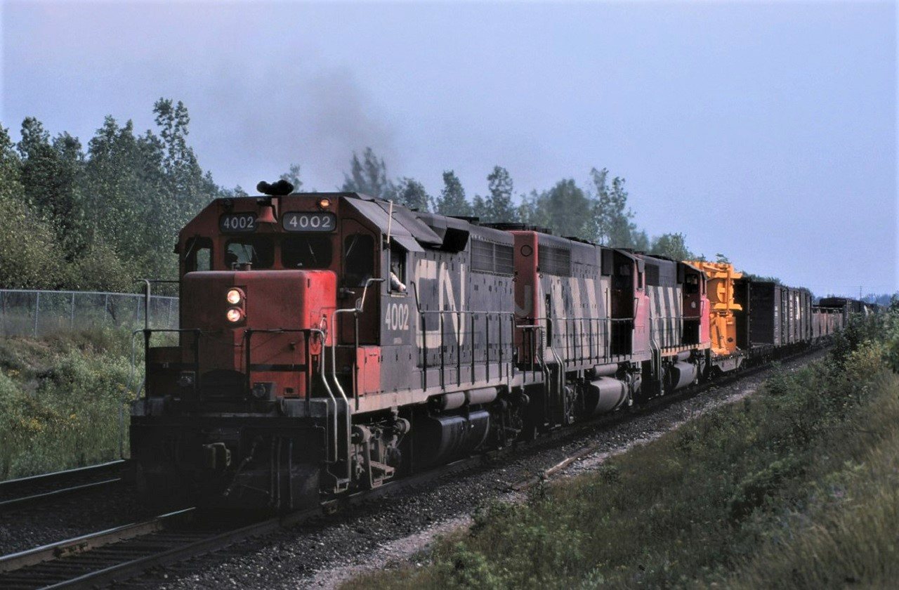 Canadian National's first GP40, 4002, leads two newer versions and a northbound (most likely westbound) freight just south of Richmond Hill, Ontario on July 19, 1980.  Power for the train is 4002, 9444, and 9475.